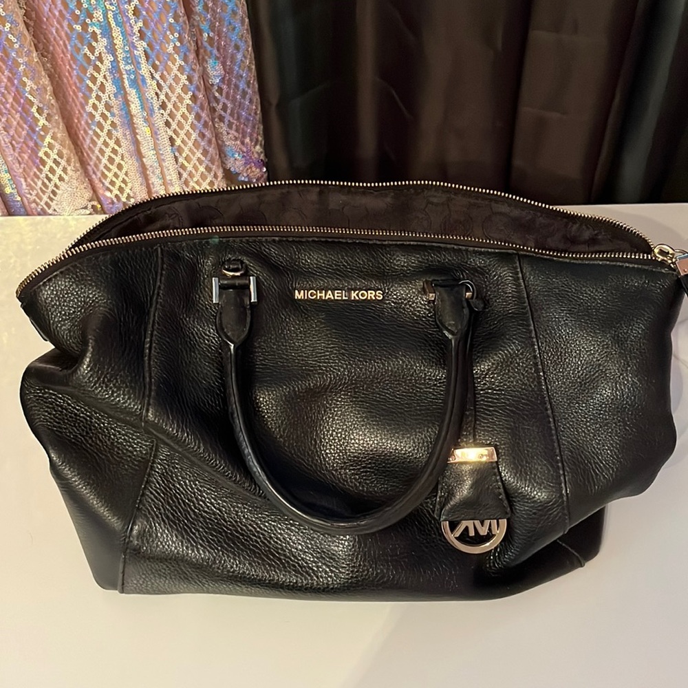 Black Michael Kors bag. Has crossbody strap inside.